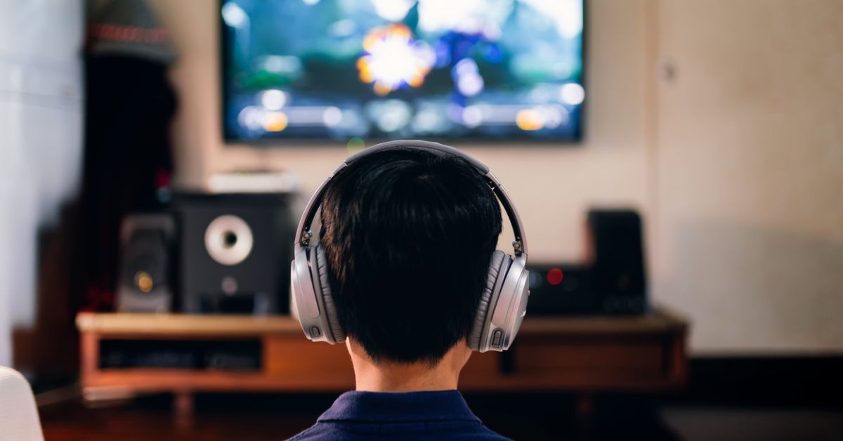 Boy enjoying game console at home
