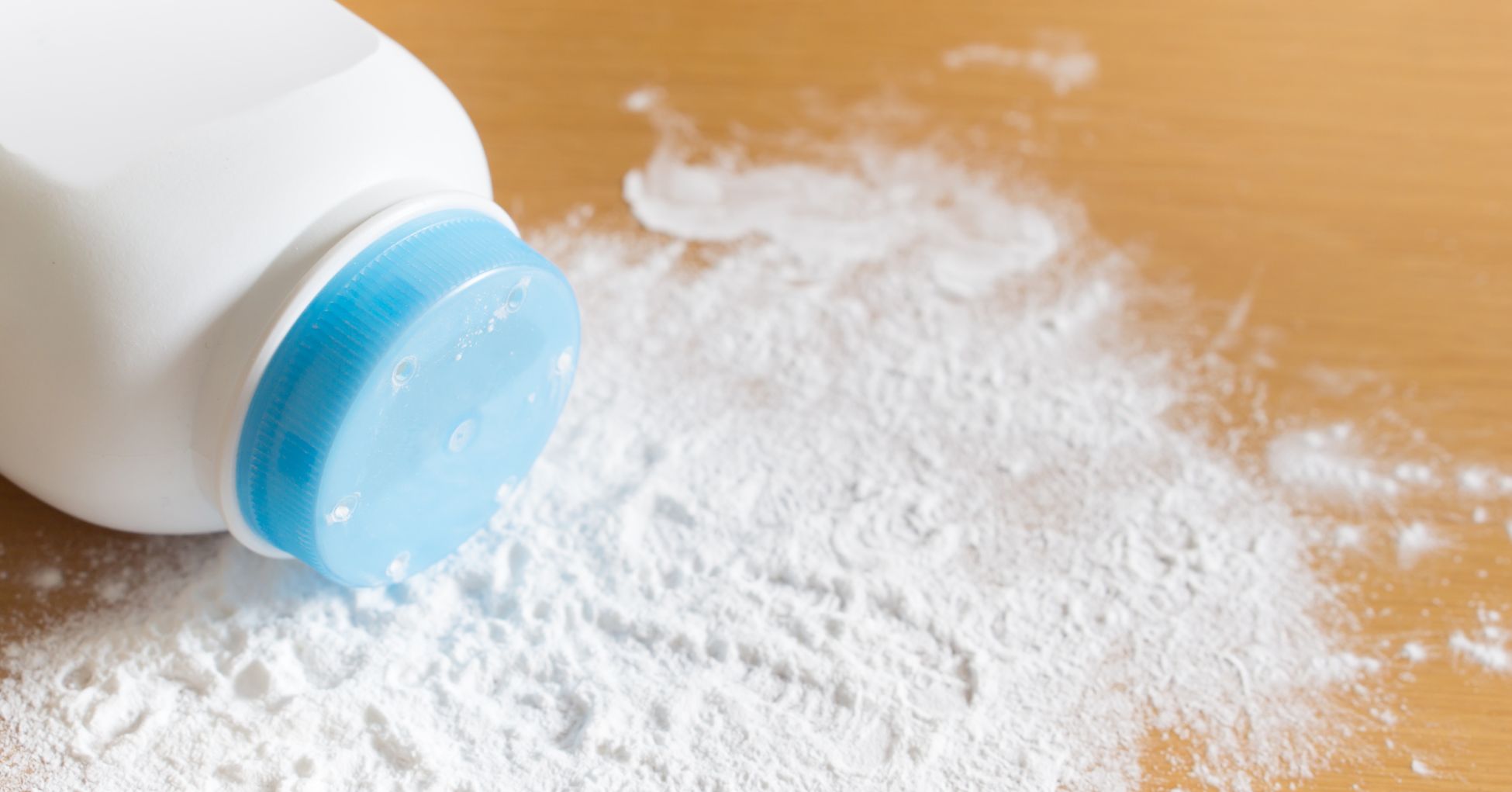 Baby talcum powder container on wooden background