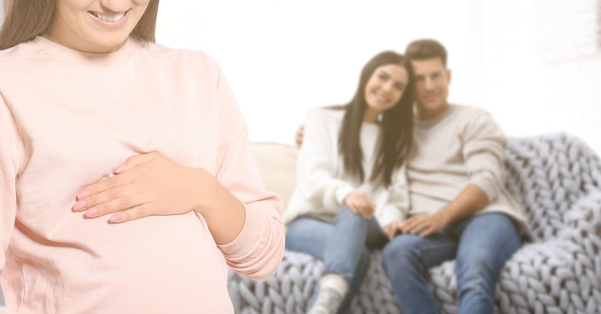 Couple looking on at their surrogate mother.