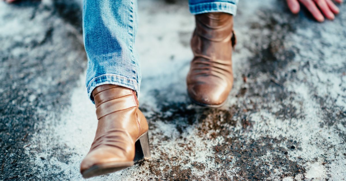 Woman in boots slipping on ice