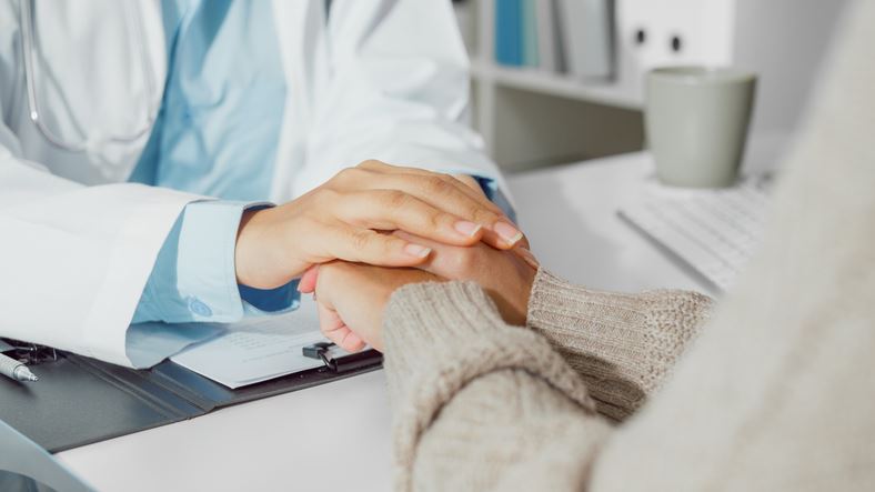 doctor holding patient hand