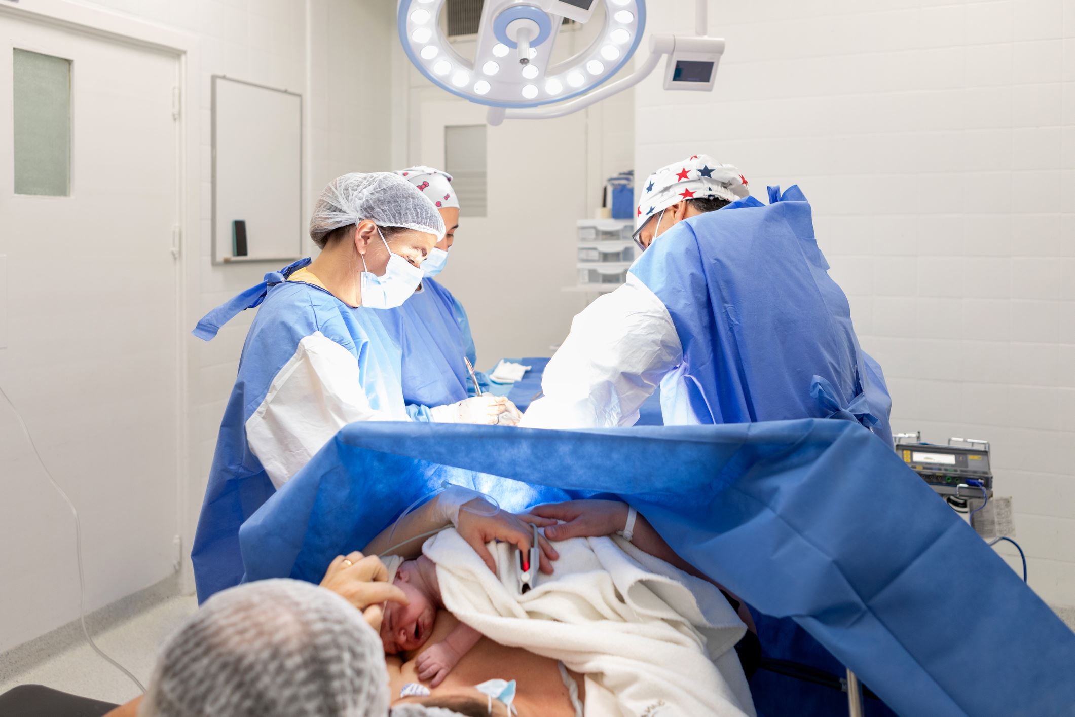 doctors assisting in giving birth