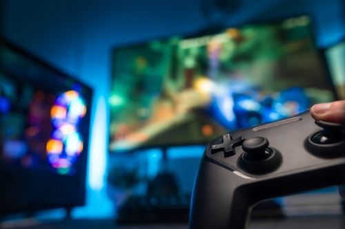 Equipment for video games - joystick, big screen TV. Video games, virtual reality, modern technologies, electronic equipment, youth culture. There are no people in the photo.