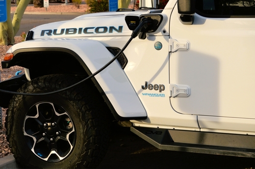 Chandler, Arizona - April 01 2023: A Jeep Wrangler Rubicon unlimited 4xe gas electric plug-in hybrid model plugged in and charging