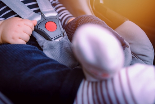 Close-up of baby sitting comfortably in car seat